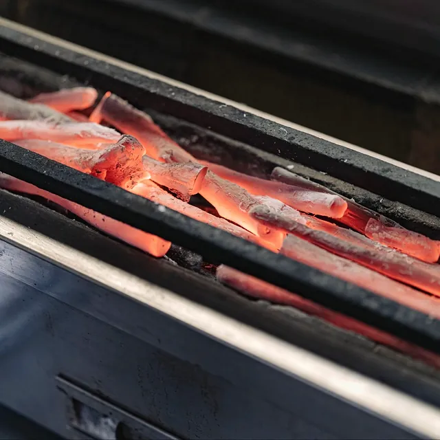 Charcoal laid in the grill at Yakitori Suzune