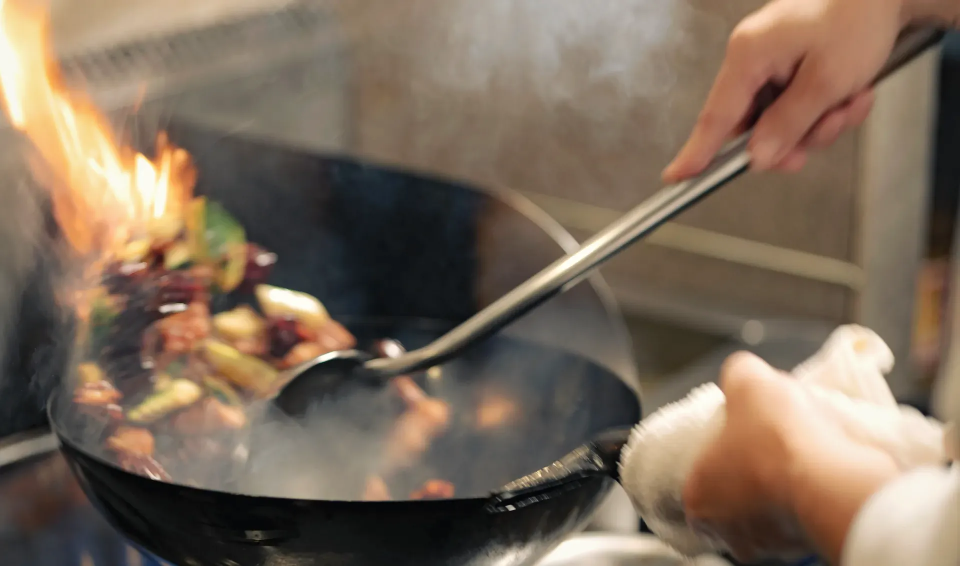 Tossing a wok in the kitchen at Yakitori Suzune